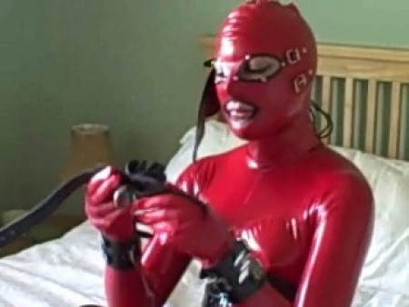 D K Bondage - Latex Model Prepares For Work